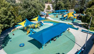 Elevated view of a play area with two separate circular play locations designed with the colors of blue and yellow.