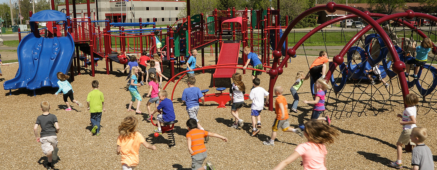 Class of kids racing to the Annandale Elementary School playground in Annandale Minnesota.