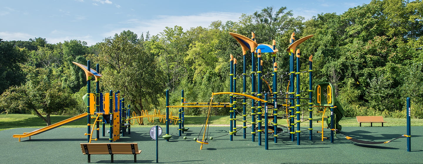 A Netplex play structure with additional play events, including climbers and slides.