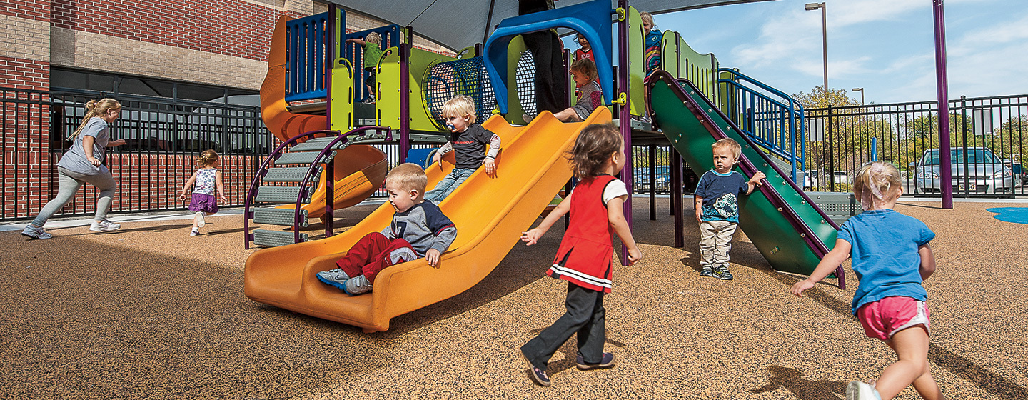 Toddler’s run and play around shaded PlayShaper playground.
