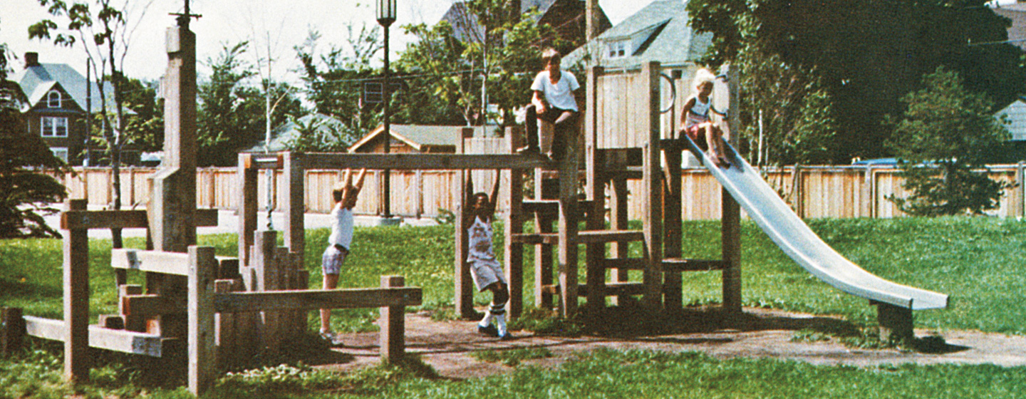 Children playing on an original 1970's Landscape Structures wood playground.
