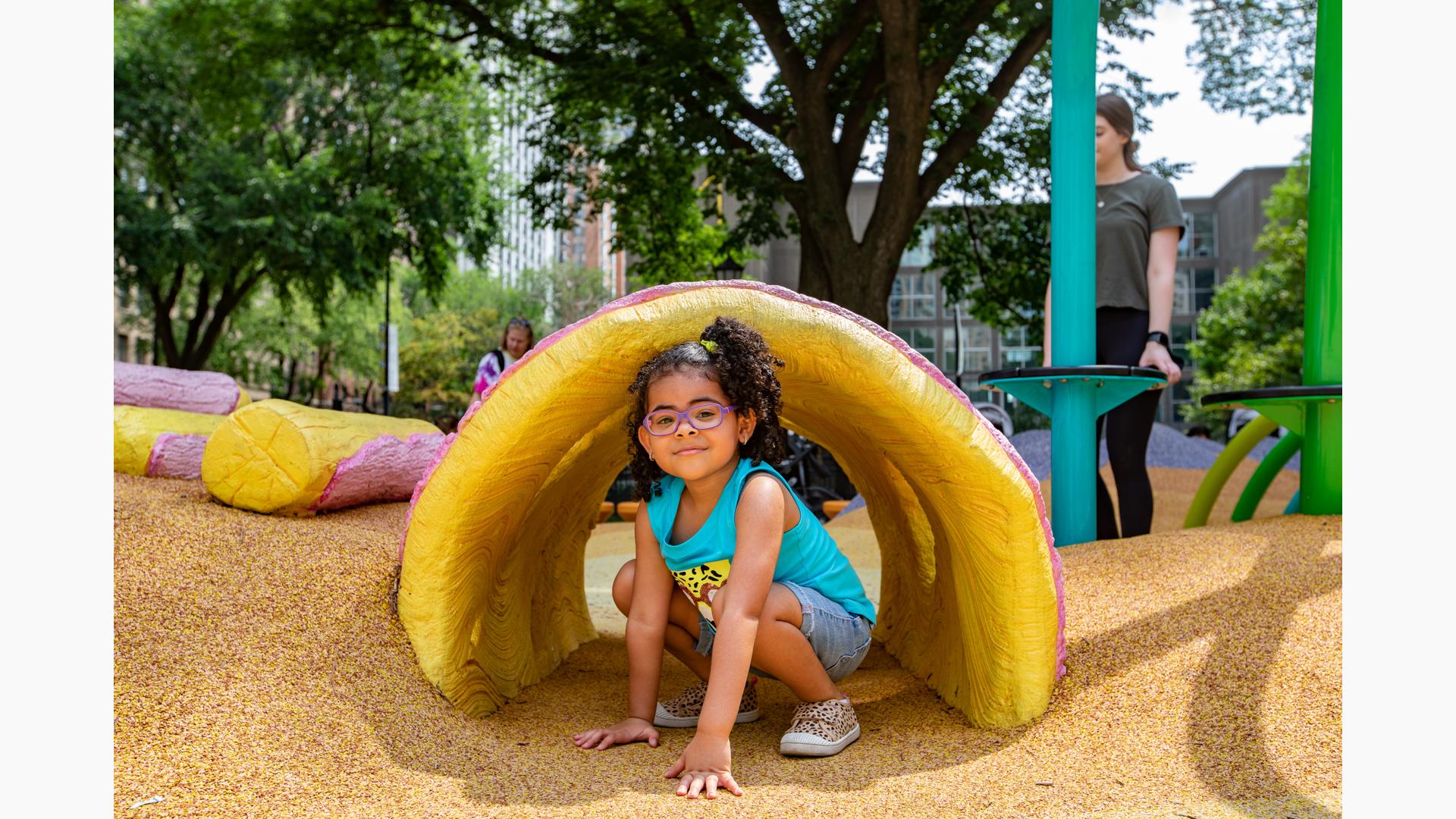 Girl sitting in tunnel structure