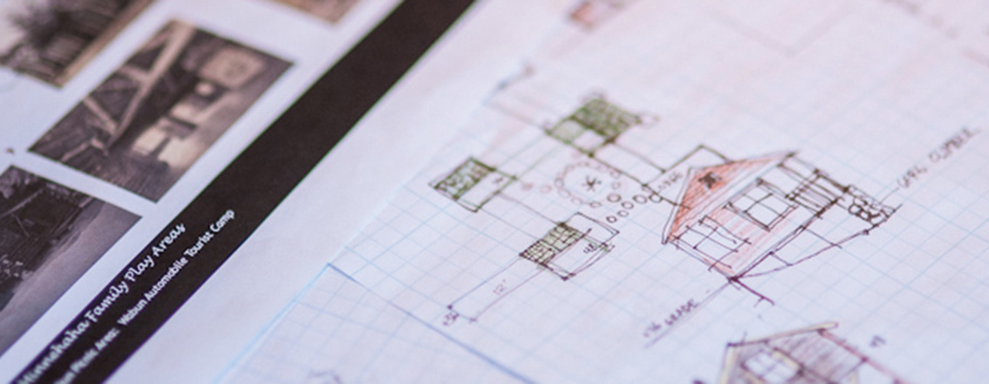 Graph paper with hand draw blueprint sketches of future playground designs.