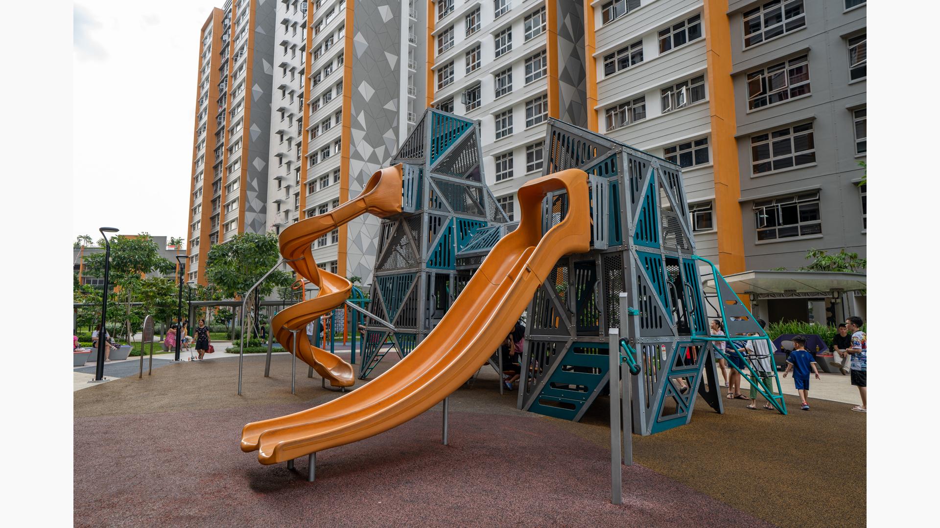 A play structure near tall apartment buildings.