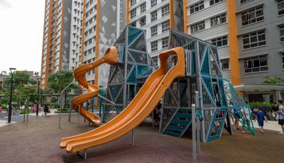 A play structure near tall apartment buildings.